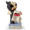 Angled view of a Jim Shore figurine showing Mickey lifting Minnie, highlighting the details of their wedding attire and the ornate base.