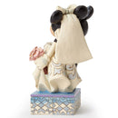 Side view of a Jim Shore Mickey and Minnie wedding figurine, displaying Minnie's bouquet and dress details.