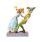 Figurine of Wendy tilting towards Peter Pan for a kiss, with Tinker Bell looking on, from Jim Shore's Disney Traditions collection.