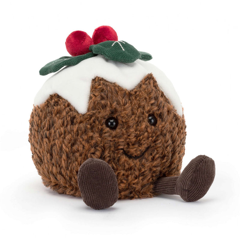 A cheerful Christmas pudding plush toy with textured brown body, white icing top, red berries, green leaves, and cute legs.