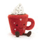 A soft plush toy shaped like a red mug with a smiling face, topped with fluffy white "whipped cream" and embroidered stars. It has cute brown feet and a handle on the side.