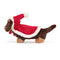 A plush toy of a brown sausage dog wearing a festive red cloak and matching hat with white trim.