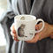 Holding a Royal Worcester Wrendale Designs - Fine Bone China Cat and Mouse Mug 310ml