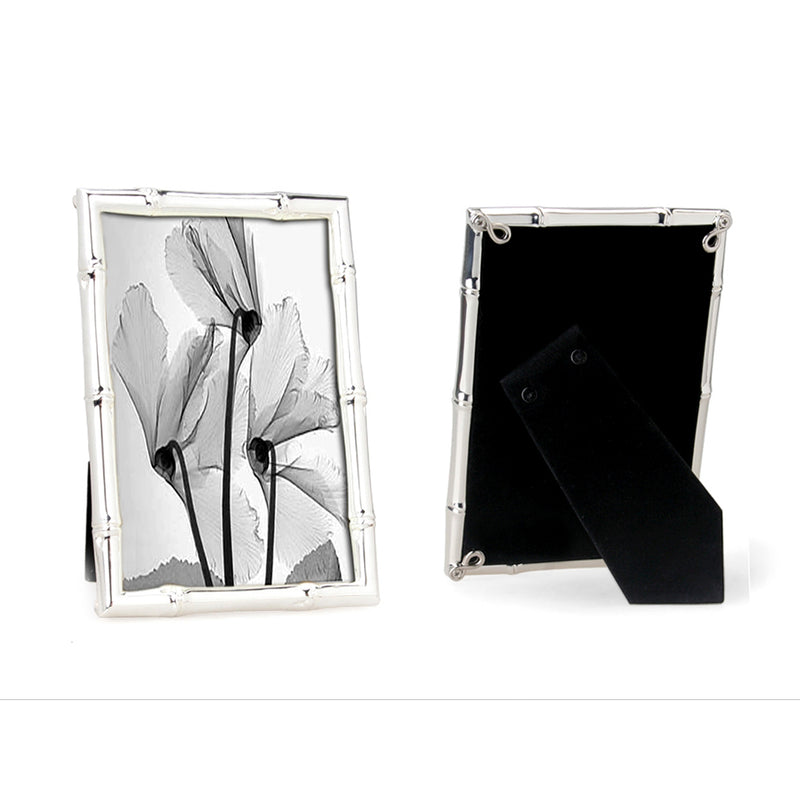 A silverplated bamboo photo frame with a 10cm x 15cm photo of flowers, displayed in portrait orientation, with a black flock backing, presented in a branded giftbox.
